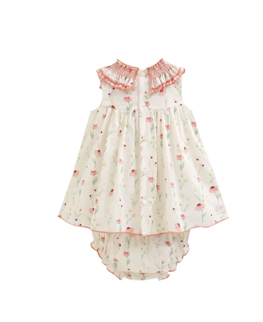 Baby dress with matching bloomers in white fabric with pink floral print and smocked detail