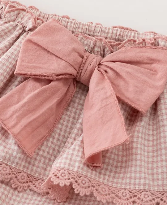 Pink plaid skirt with bow detail at waistband