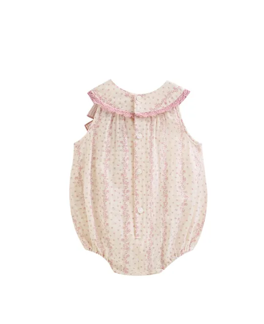 White bubble romper with pink floral print and pink ruffle collar