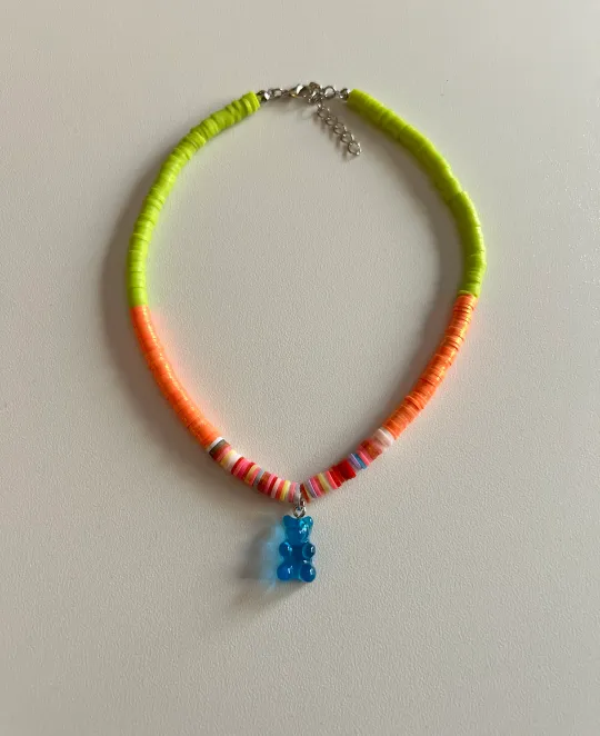 Rope necklace with yellow and orange sections and blue bear charm pendant