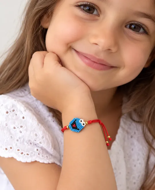 Girl wearing colorful beaded bracelet with blue center bead on wrist