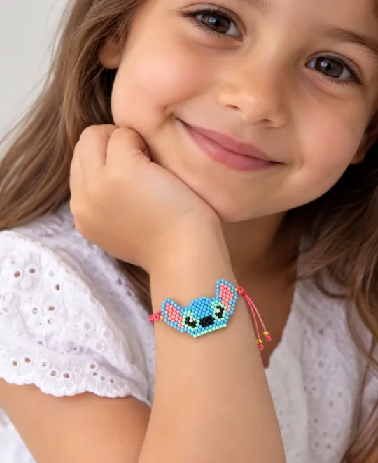 Child wearing temporary tattoo of blue cartoon character on wrist