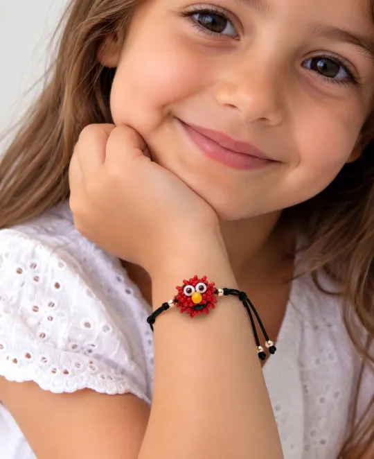 Girl wearing red beaded bracelet with white eyelet top