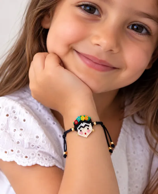 Young girl wearing a beaded bracelet with a small flower charm