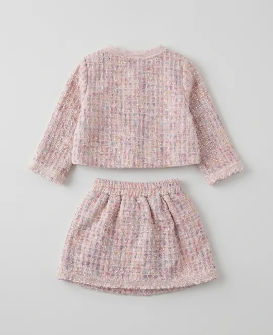 Pink tweed long-sleeve top and skirt set laid flat