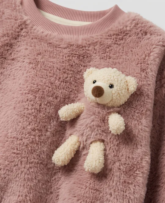 Pink fuzzy sweater with cream teddy bear appliqué on chest