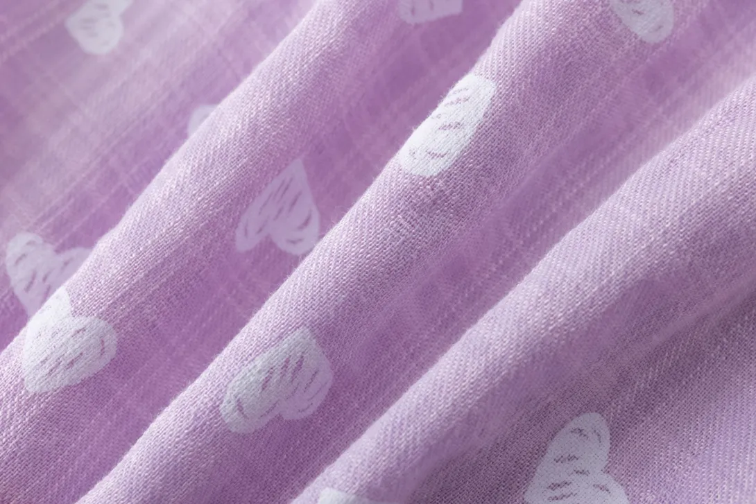 Purple fabric with white cloud pattern in diagonal folds