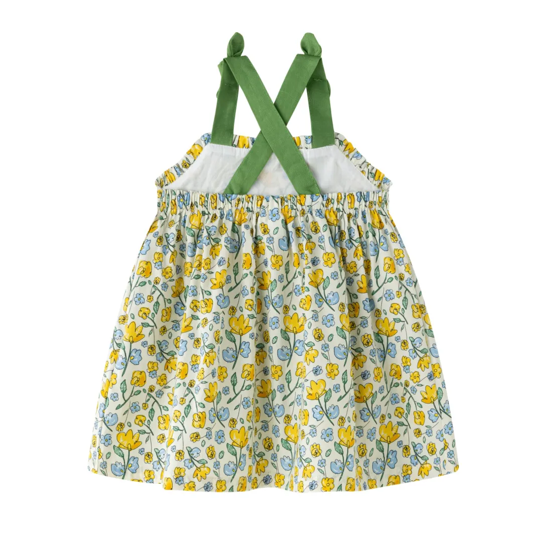 Yellow and white floral print dress with green crossback straps