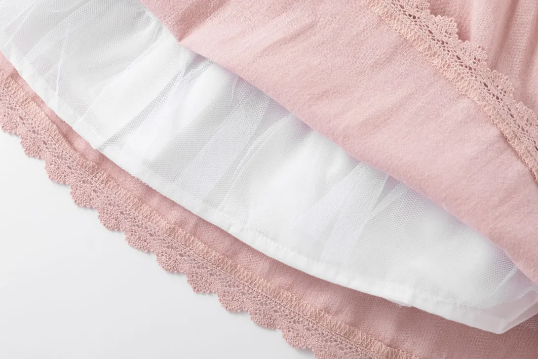 Pink and white ruffled fabric with lace trim detail