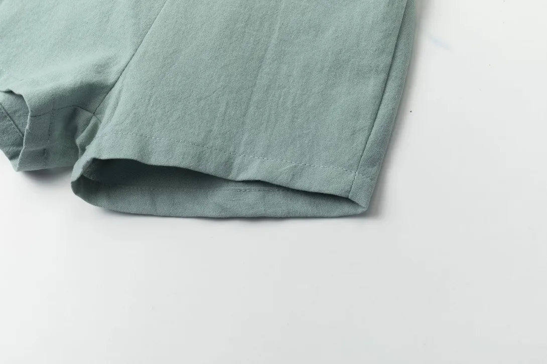 Blue-gray folded fabric pants on white background