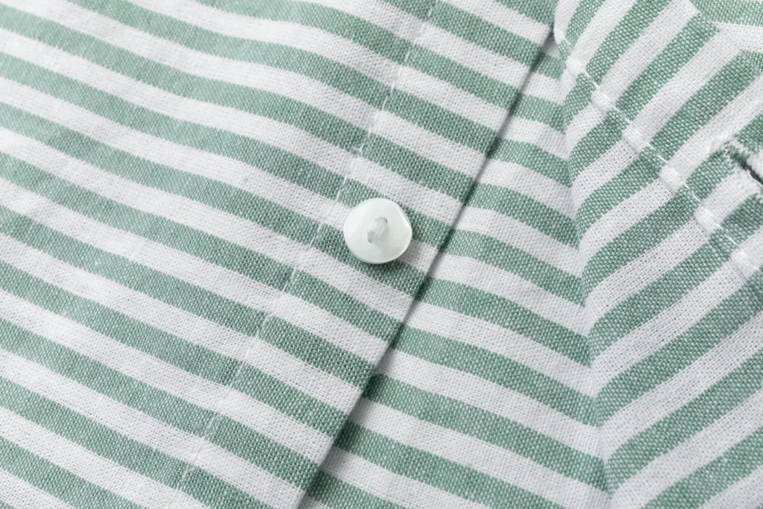 Green and white striped fabric with white button detail