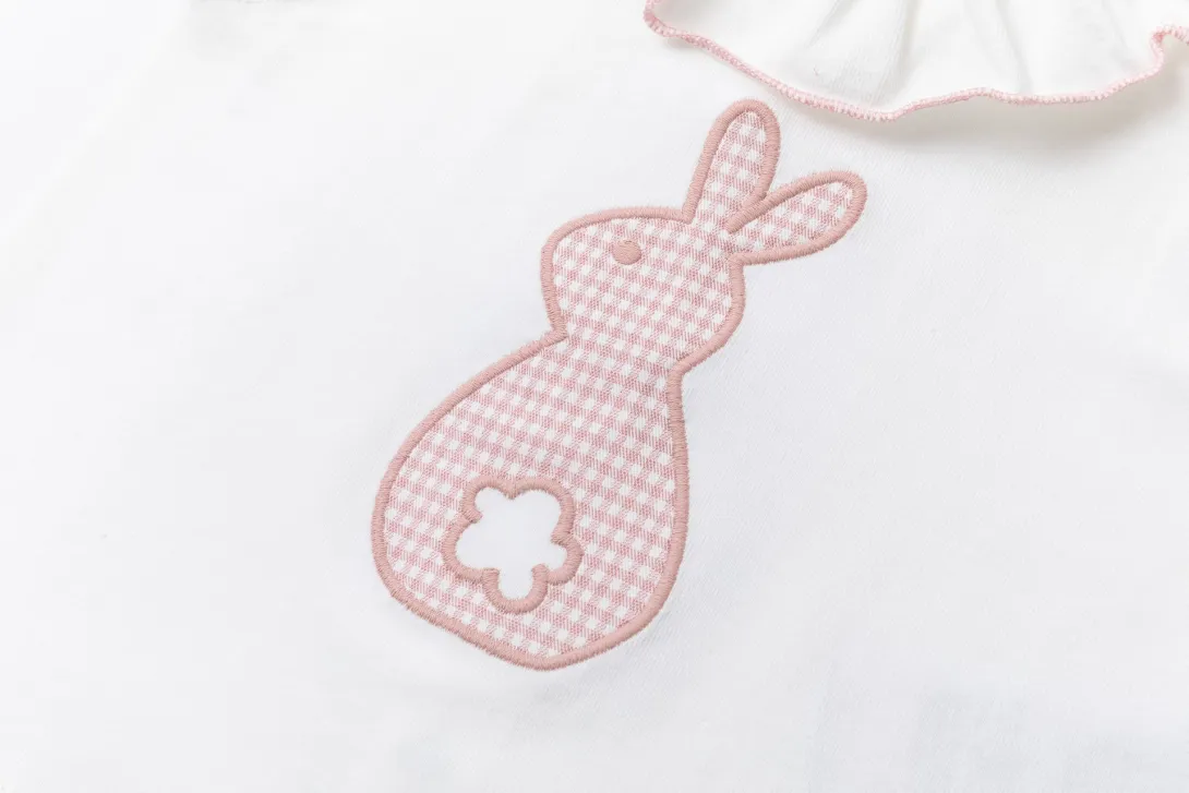 Pink gingham bunny-shaped rattle with white ribbon attached
