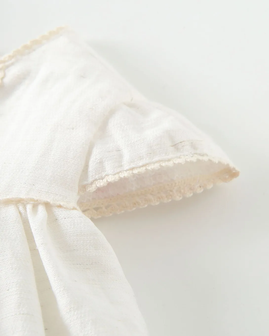 White linen napkin with decorative fringe trim