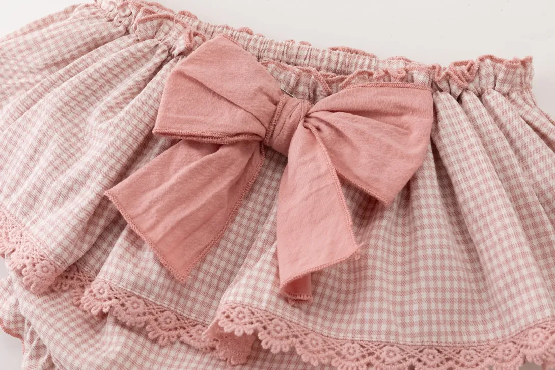 Pink plaid skirt with bow detail at waistband