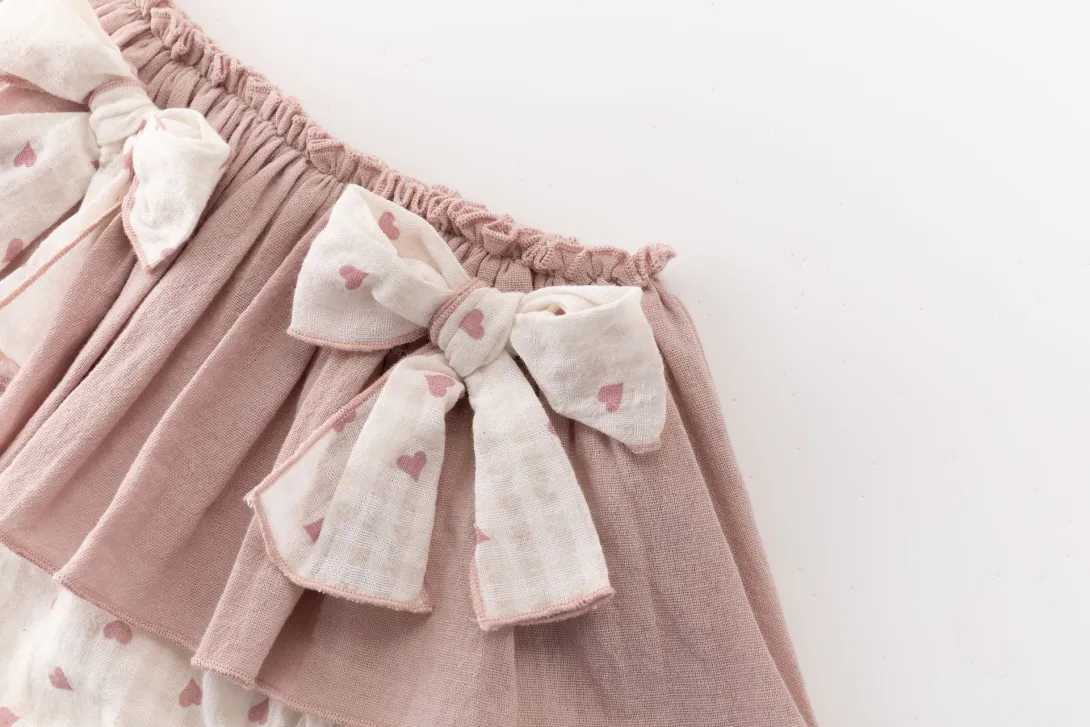 Pink tulle skirt with white polka dot ribbon bow detail at waistband