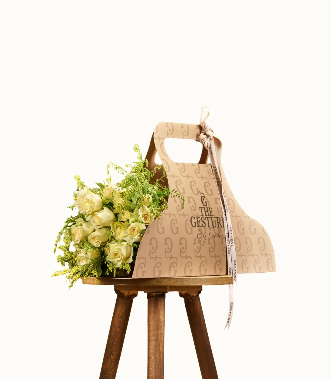 Wooden cutting board with handle hanging on stand with yellow flowers