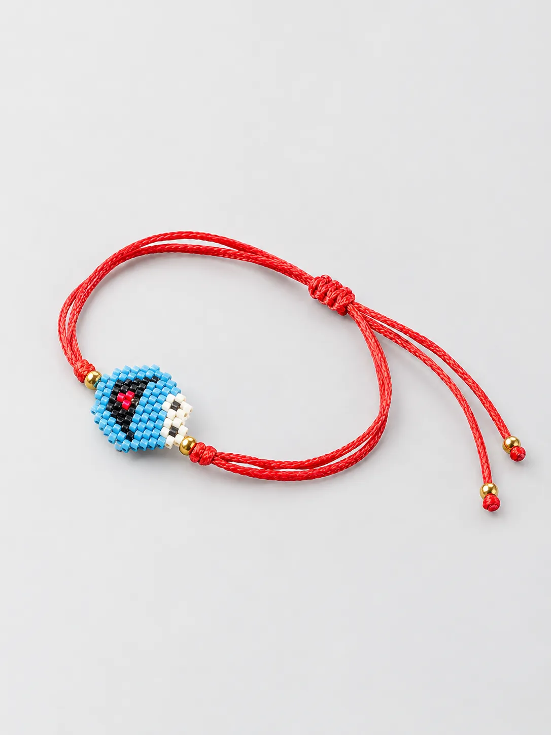 Red cord bracelet with blue mosaic square centerpiece and adjustable closure
