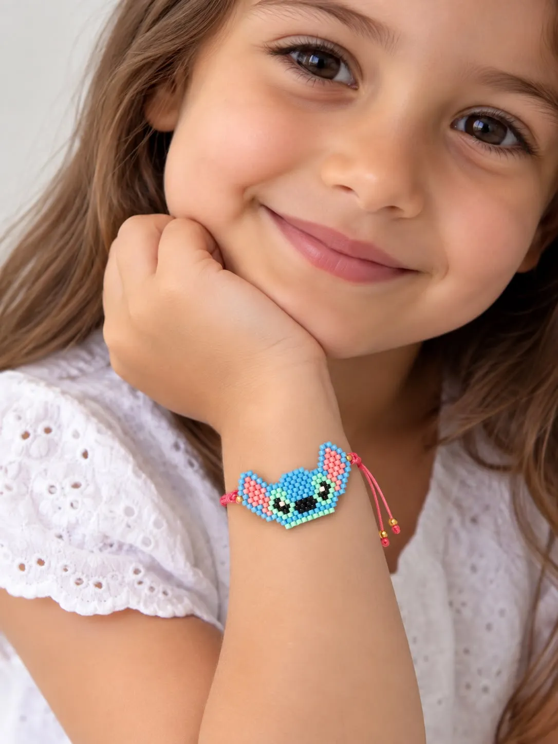 Child wearing temporary tattoo of blue cartoon character on wrist