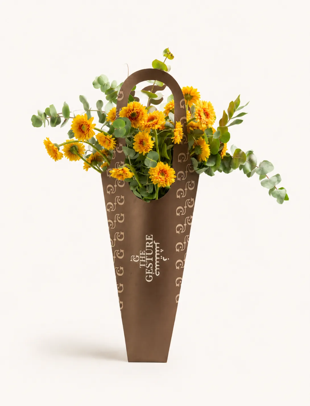Yellow and orange floral arrangement in a tall brown woven basket vase