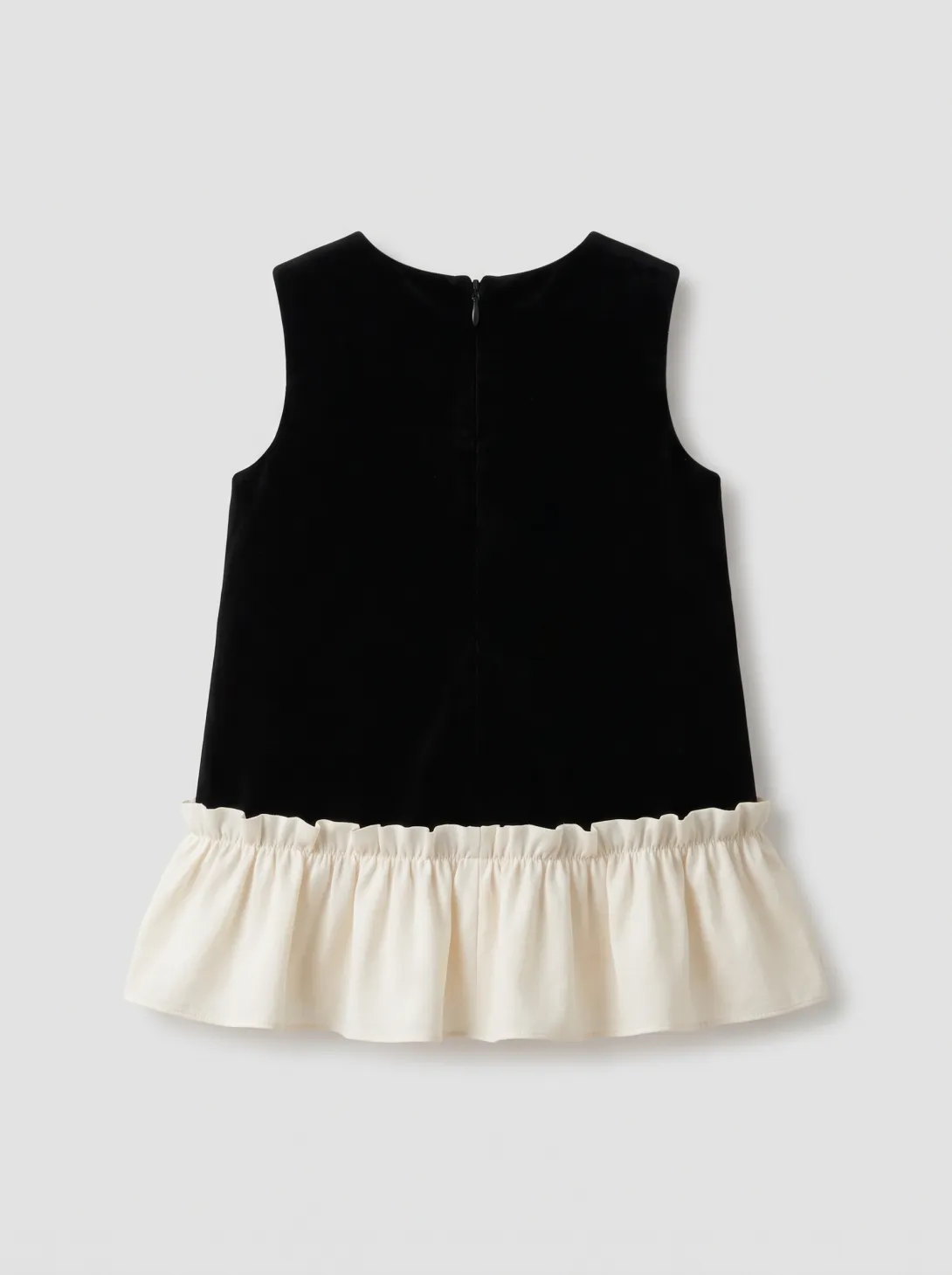 Black sleeveless top with cream-colored ruffled hem