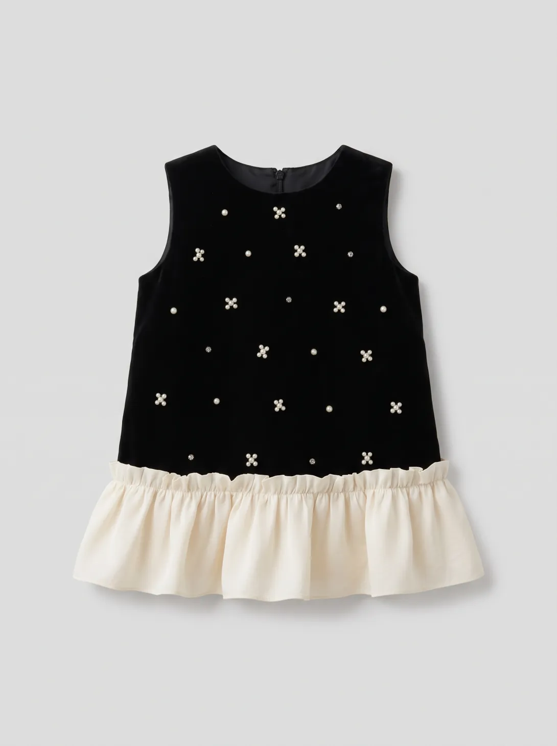 Black sleeveless top with star embroidery and cream ruffle hem