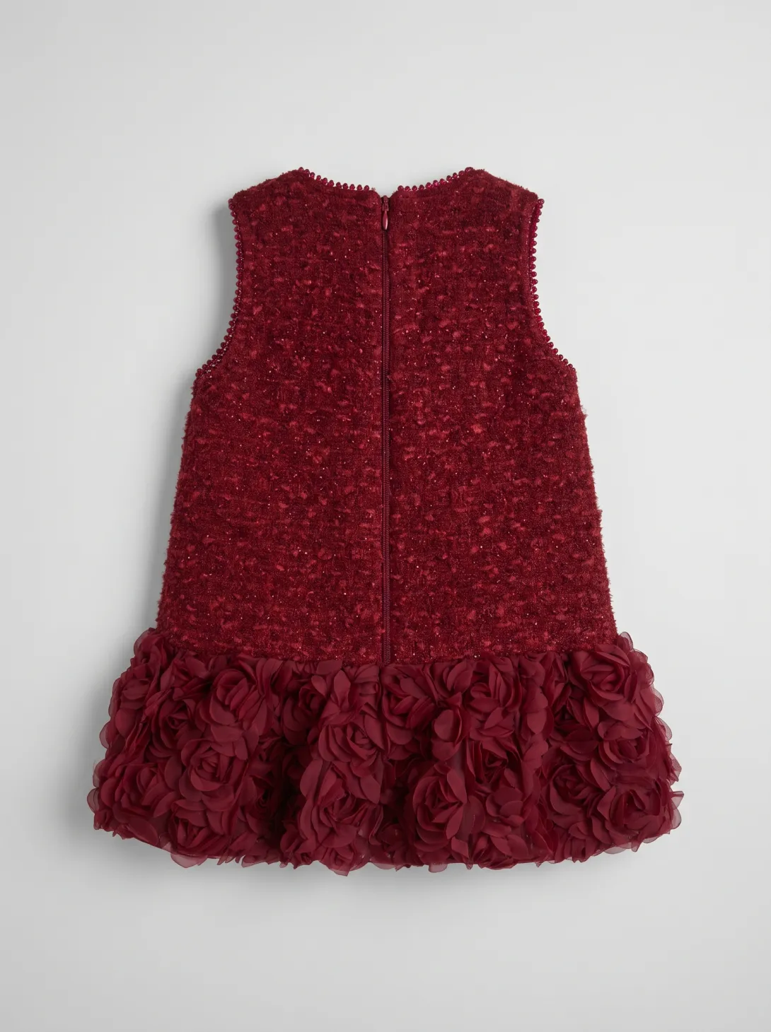Burgundy sleeveless dress with textured fabric and ruffled hem